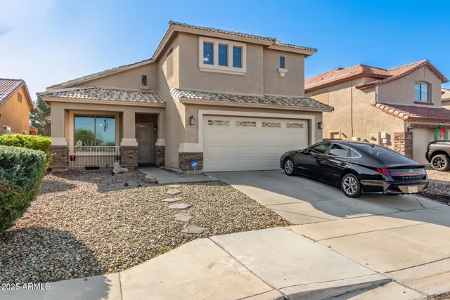 a car parked in front of a white house