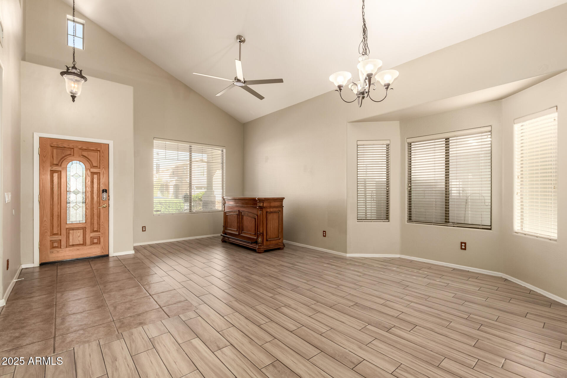 4403 West Maldonado Road Laveen, AZ 85339 - Photo 7 of 37 a view of an empty room with a window and wooden floor