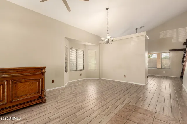 a view of an empty room with window wooden floor and fire place