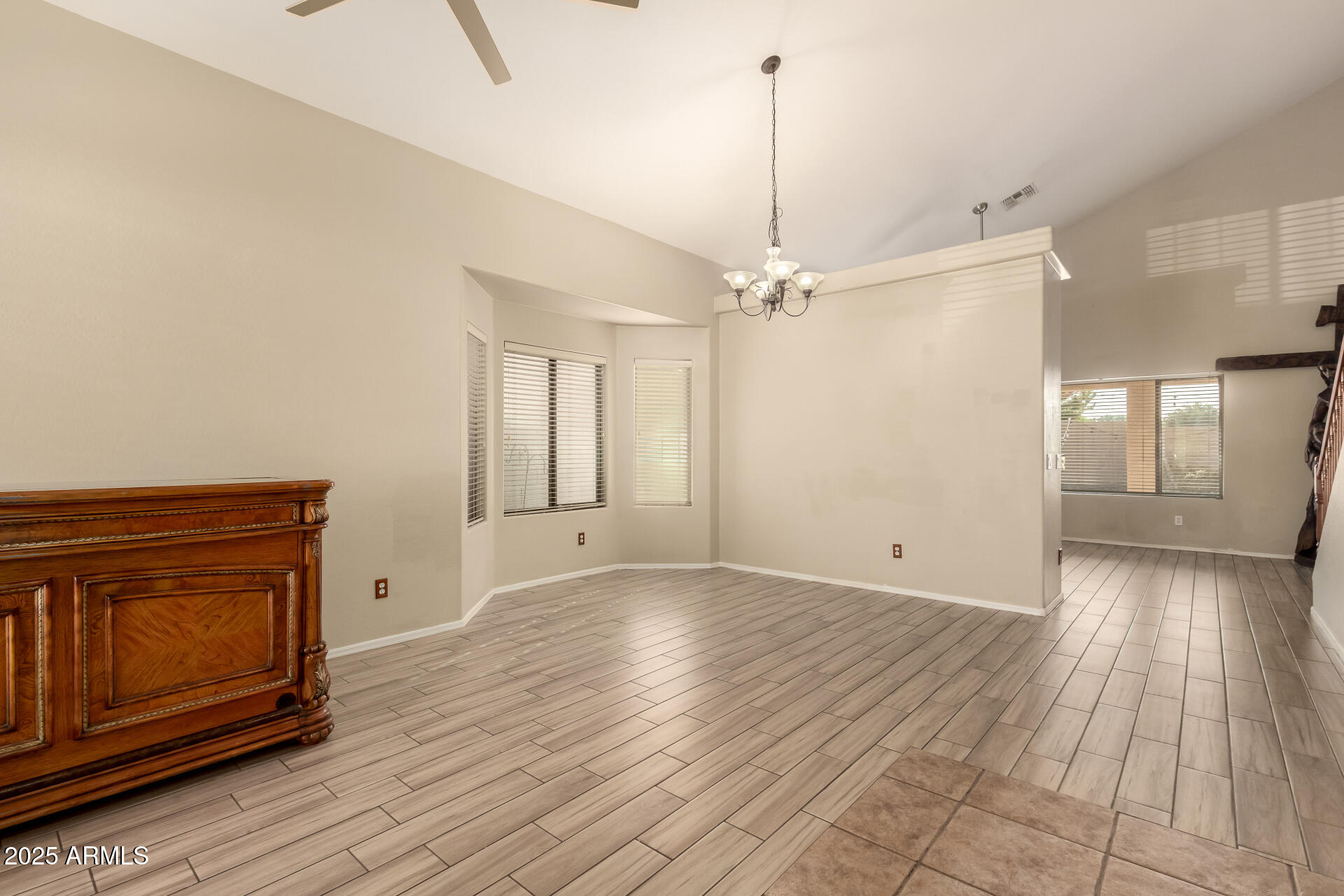 4403 West Maldonado Road Laveen, AZ 85339 - Photo 8 of 37 a view of an empty room with window wooden floor and fire place