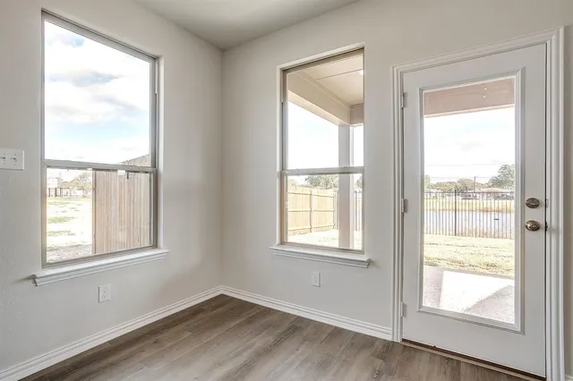 an empty room with closet and a bathroom