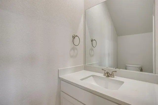 a view of a kitchen with a refrigerator and a stove top oven