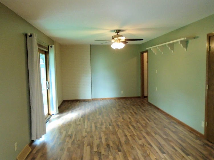 202 Linder Lane Rochelle, IL 61068 - Photo 3 of 17 a view of empty room with wooden floor and fan