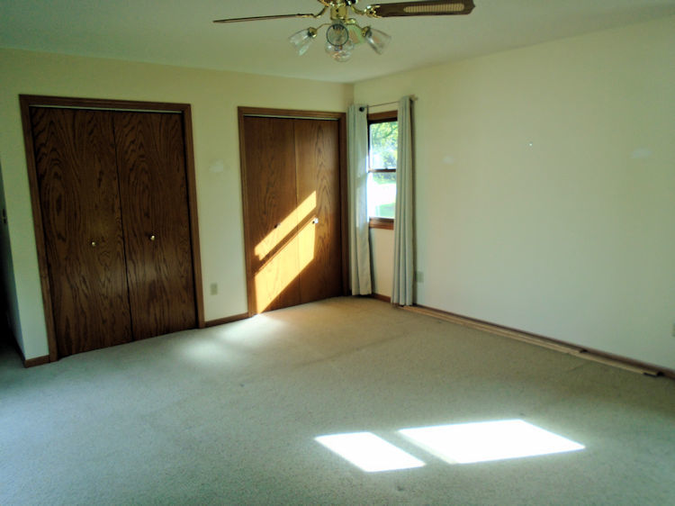202 Linder Lane Rochelle, IL 61068 - Photo 6 of 17 an empty room with a window and a ceiling fan