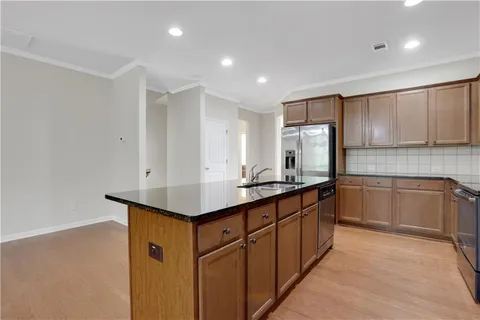 a kitchen with stainless steel appliances granite countertop a sink and cabinets
