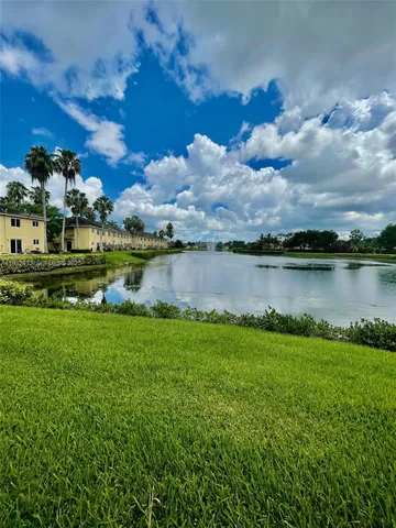 a view of a lake with houses in the back
