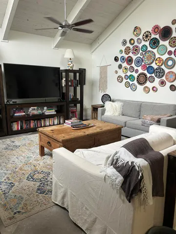 a bedroom with two beds and a flat screen tv