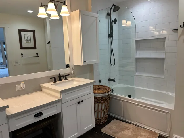 a bathroom with a double vanity sink mirror and shower