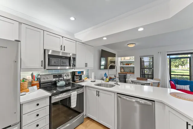 a kitchen that has a sink and a stove in it