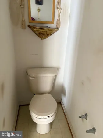 a white toilet sitting next to a sink