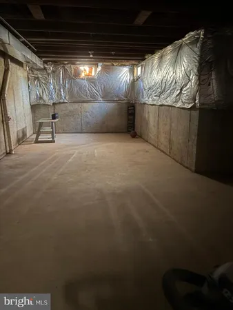 a view of empty room with wooden walls