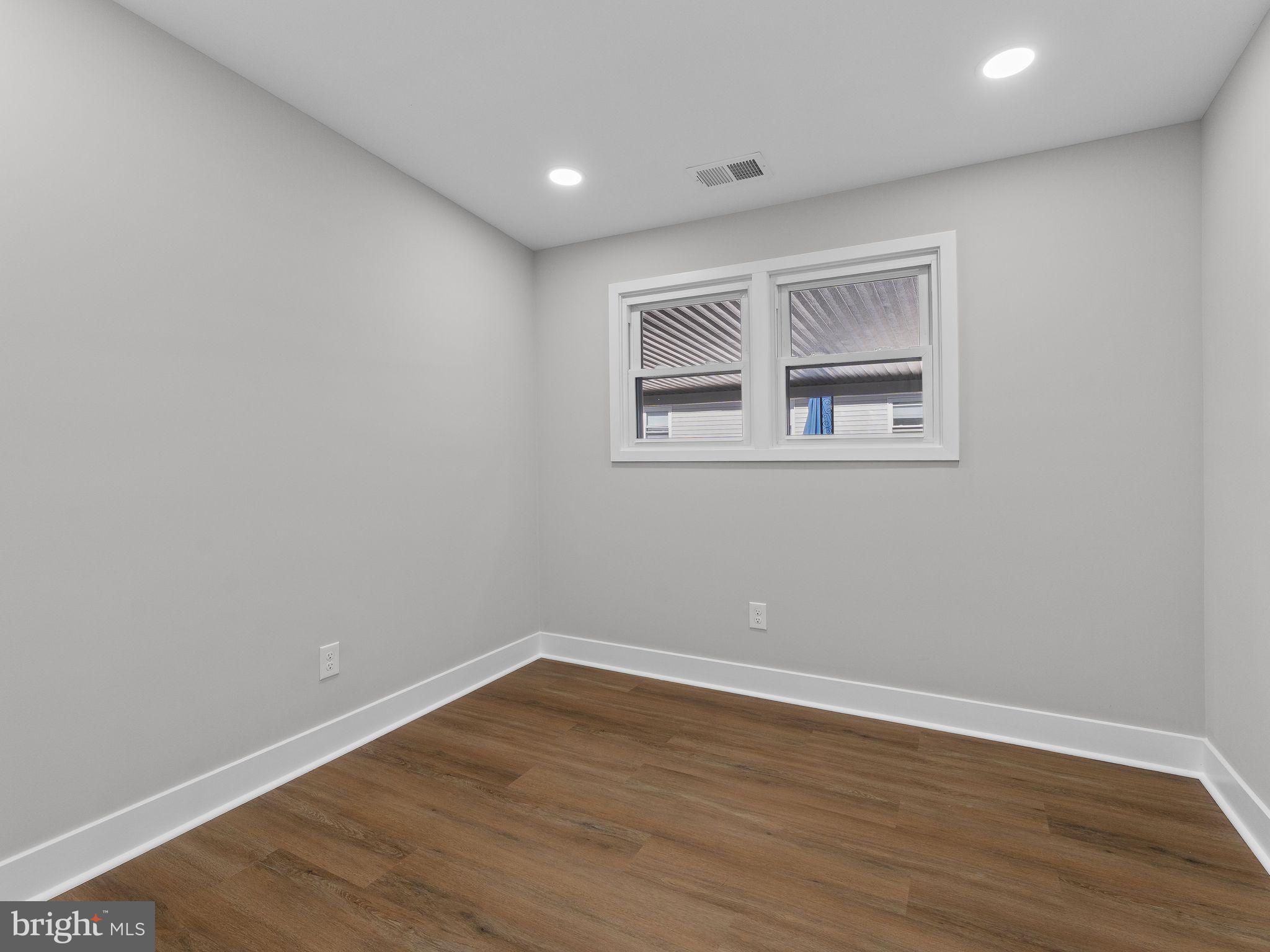 9314 Trout Road Philadelphia, PA 19115 - Photo 11 of 23 a view of empty room with wooden floor and fan
