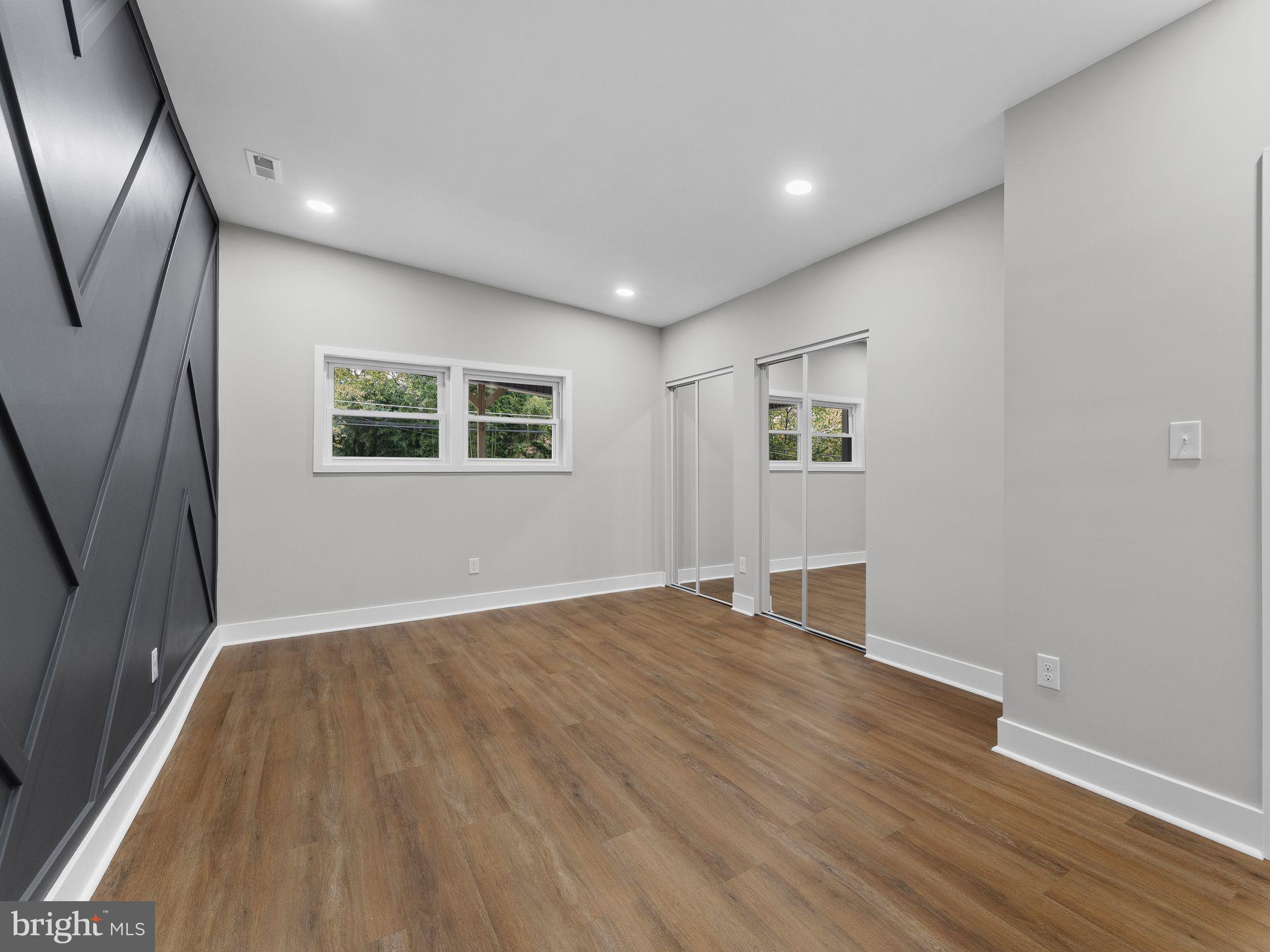 9314 Trout Road Philadelphia, PA 19115 - Photo 16 of 23 a view of an empty room with wooden floor and a window