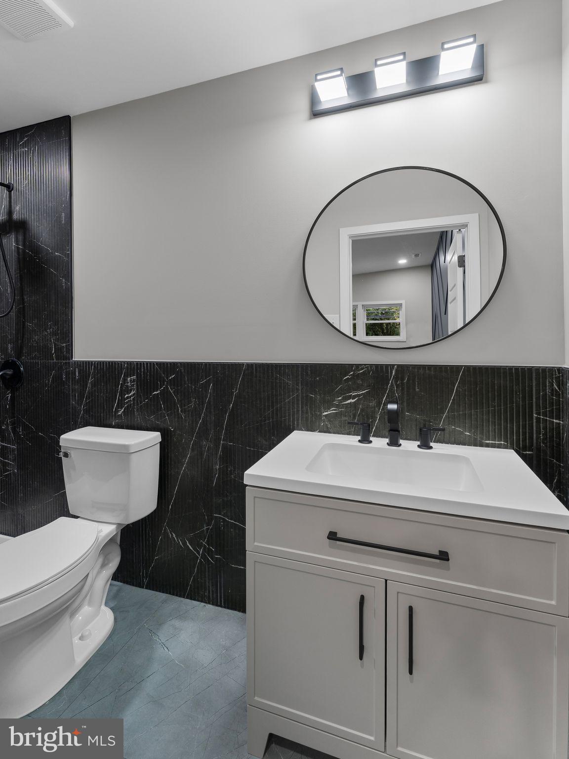 9314 Trout Road Philadelphia, PA 19115 - Photo 18 of 23 a bathroom with a toilet sink and mirror