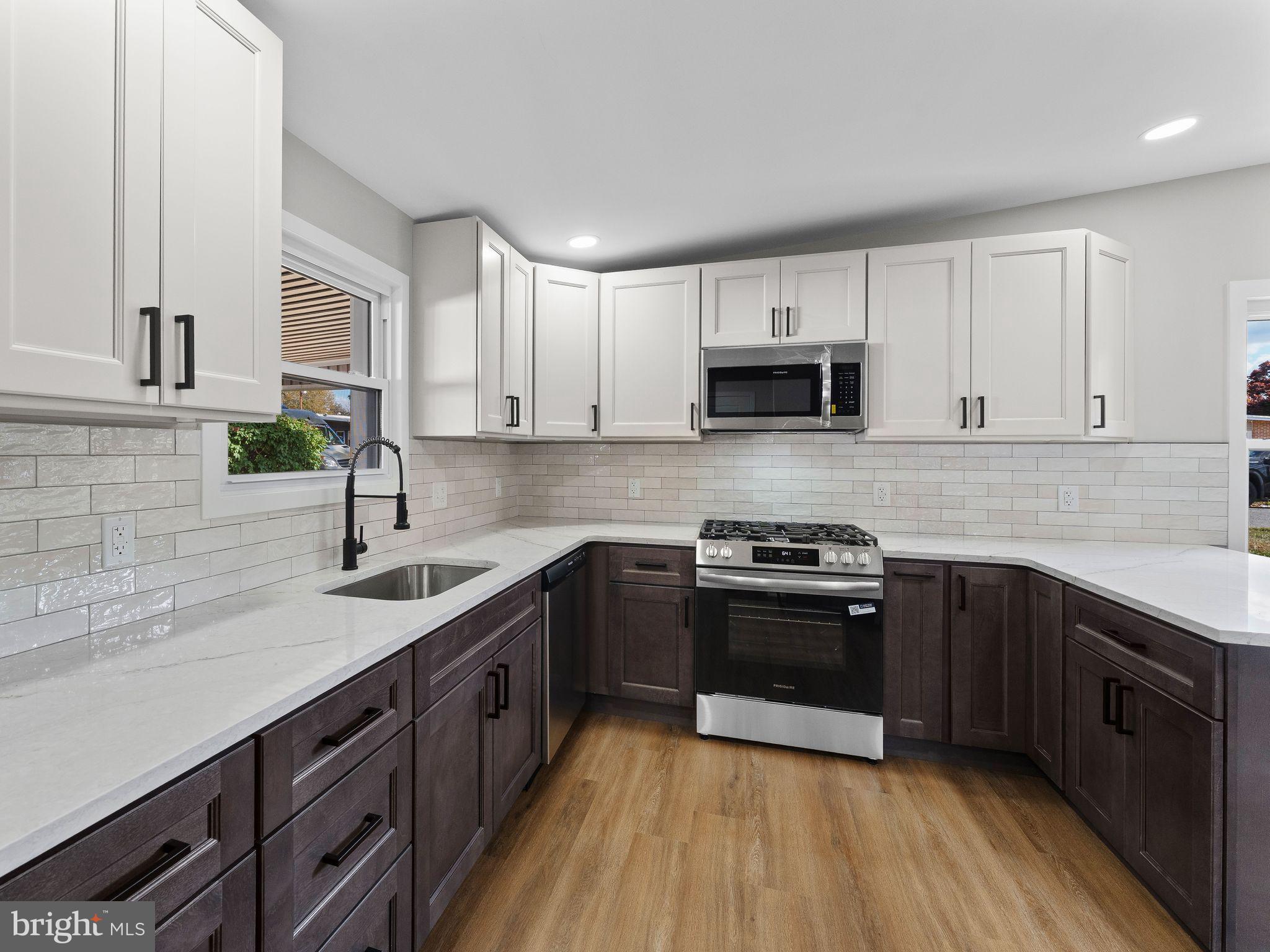 9314 Trout Road Philadelphia, PA 19115 - Photo 2 of 23 a kitchen with a sink stove and cabinets