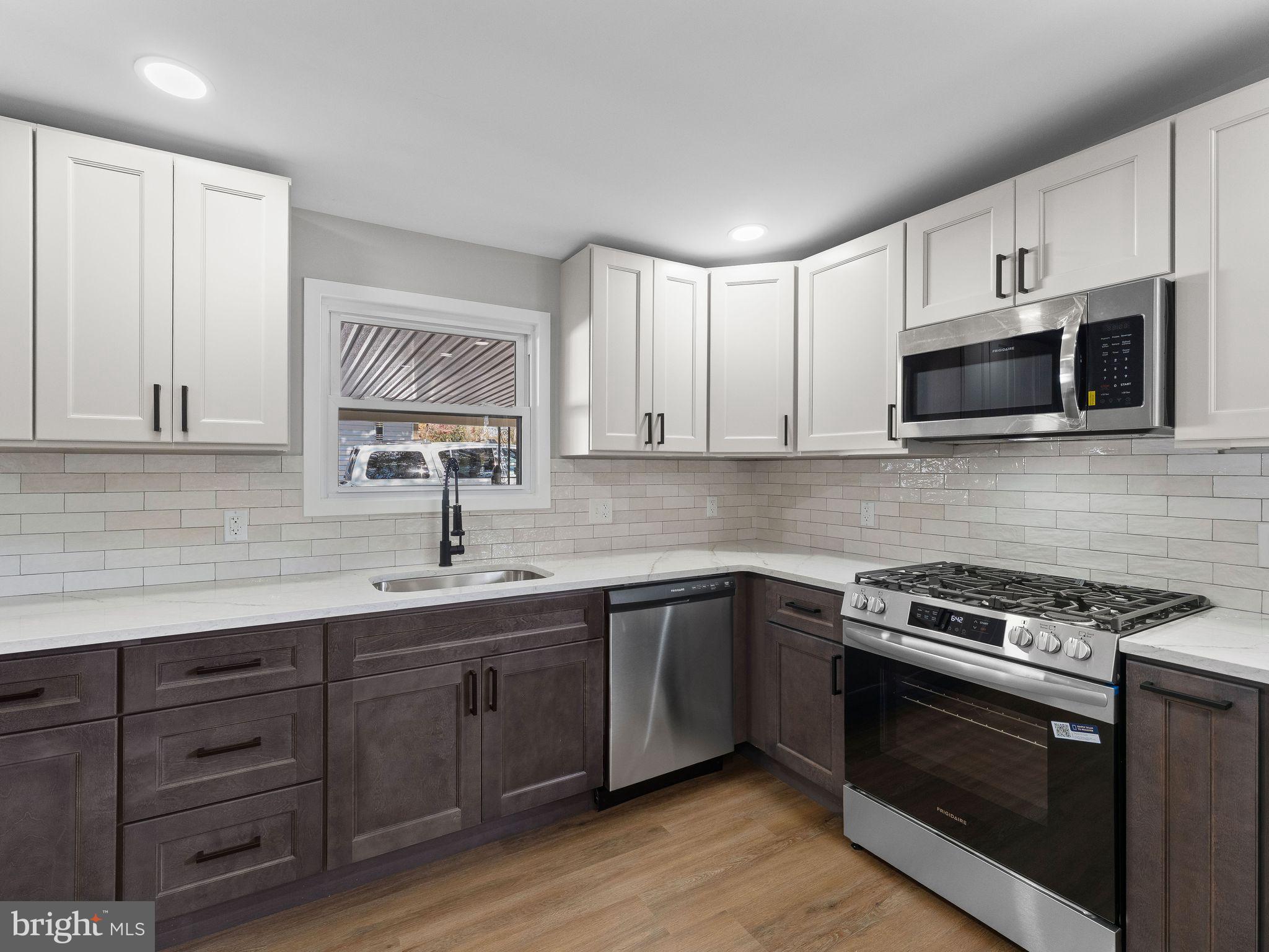 9314 Trout Road Philadelphia, PA 19115 - Photo 3 of 23 a kitchen with sink a microwave and cabinets
