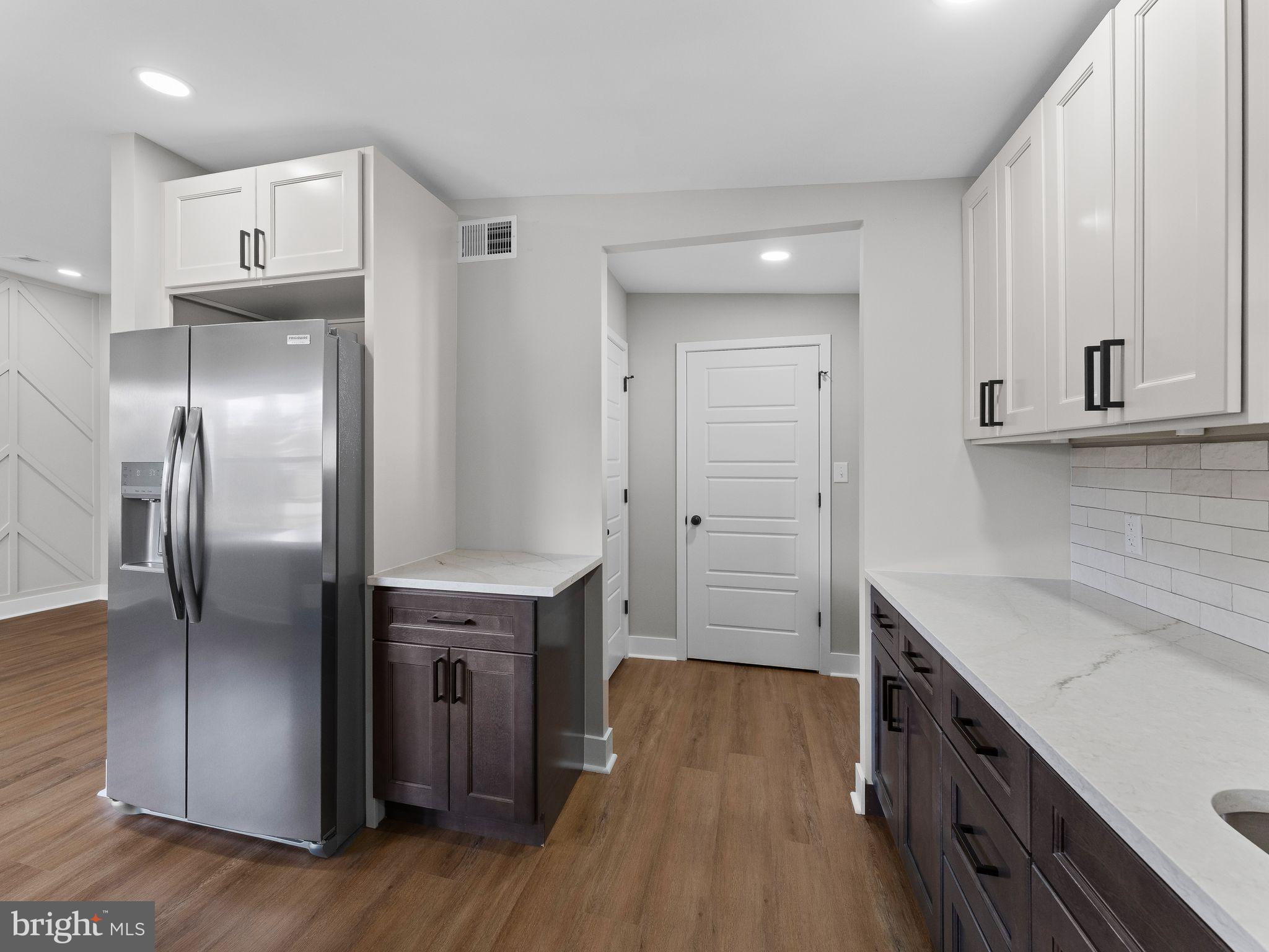 9314 Trout Road Philadelphia, PA 19115 - Photo 4 of 23 a kitchen with a refrigerator sink and cabinets