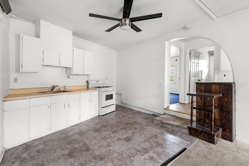 47 Riverside Drive North Reading, MA 01864 - Photo 17 of 34 a kitchen with granite countertop a sink cabinets stainless steel appliances and a chandelier