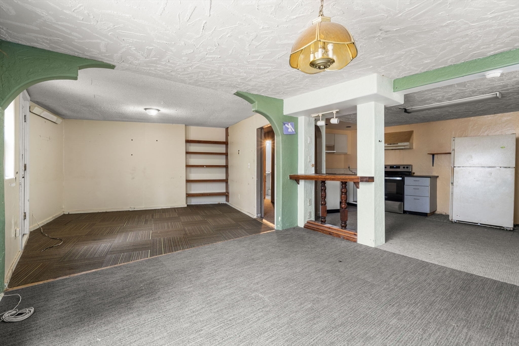 47 Riverside Drive North Reading, MA 01864 - Photo 21 of 34 a view of an empty room with a kitchen