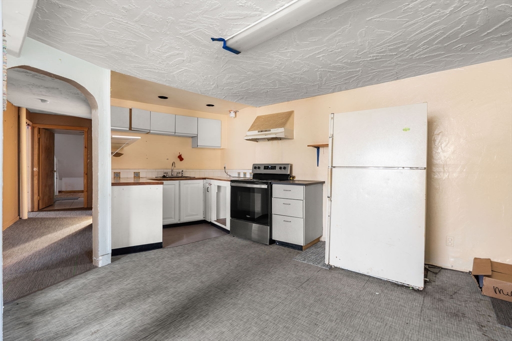 47 Riverside Drive North Reading, MA 01864 - Photo 23 of 34 a kitchen with white cabinets and white appliances