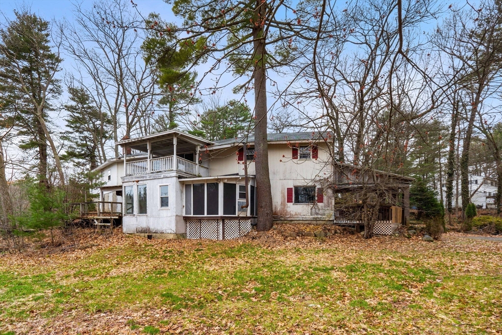 47 Riverside Drive North Reading, MA 01864 - Photo 29 of 34 a front view of a house with a yard covered with trees