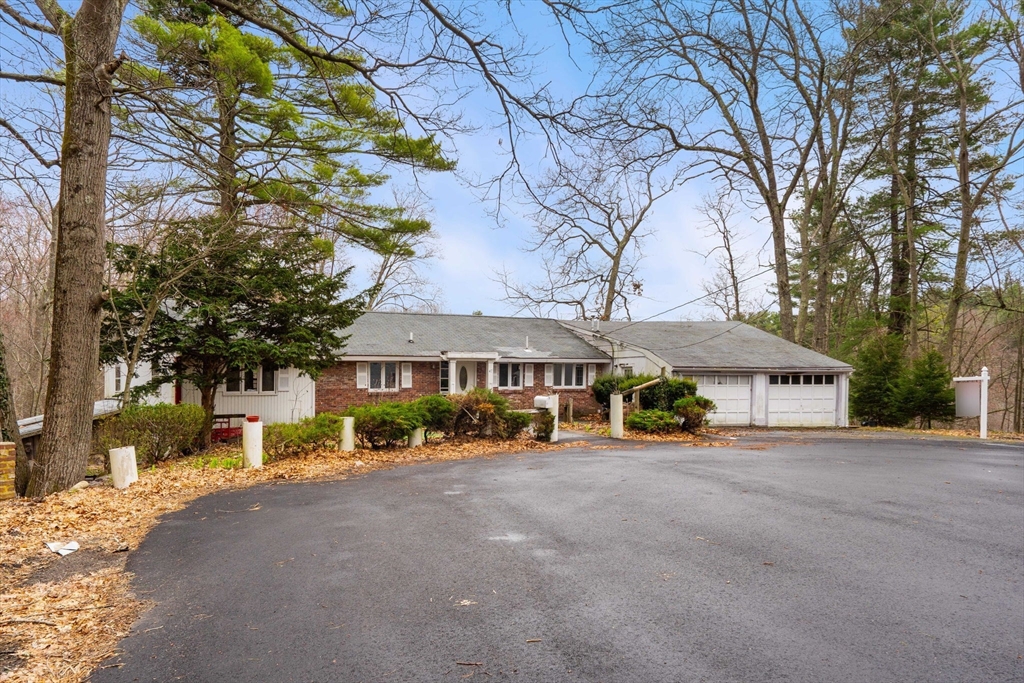 47 Riverside Drive North Reading, MA 01864 - Photo 3 of 34 a view of a house with a large tree and a big yard