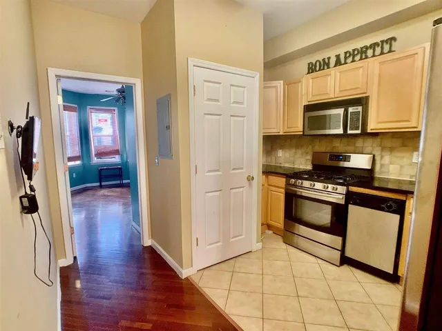 a kitchen with stainless steel appliances a stove a microwave and a refrigerator