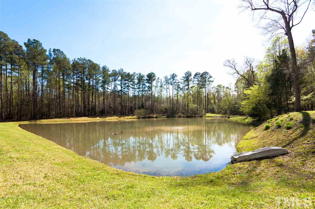 7016 Farmdale Road Raleigh, NC 27610 - Photo 22 of 25 a view of a swimming pool with a yard