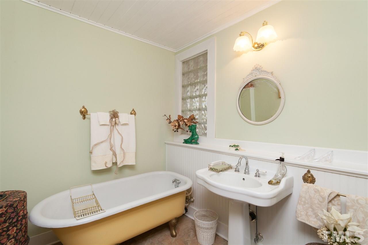 7016 Farmdale Road Raleigh, NC 27610 - Photo 8 of 25 a bathroom with a sink and a mirror