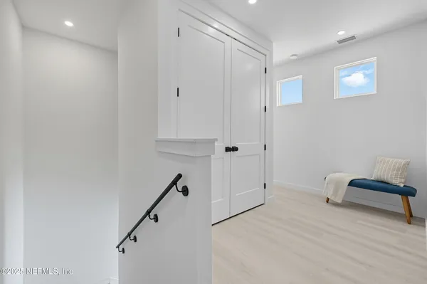 a view of entryway and hall with wooden floor