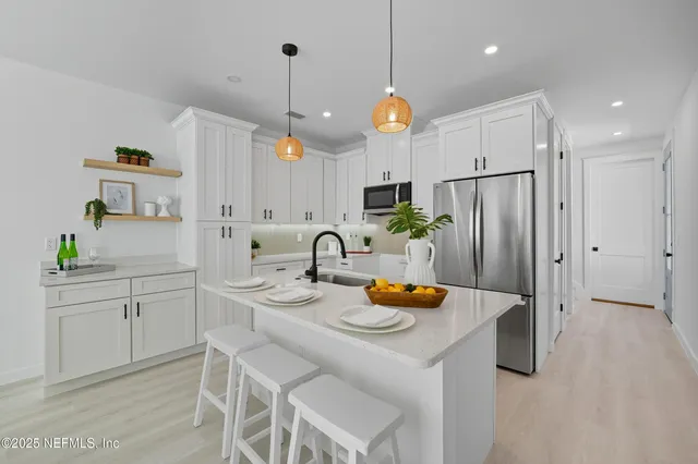 a kitchen with a sink and a chandelier