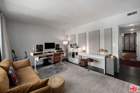 a hallway with a sink and a mirror