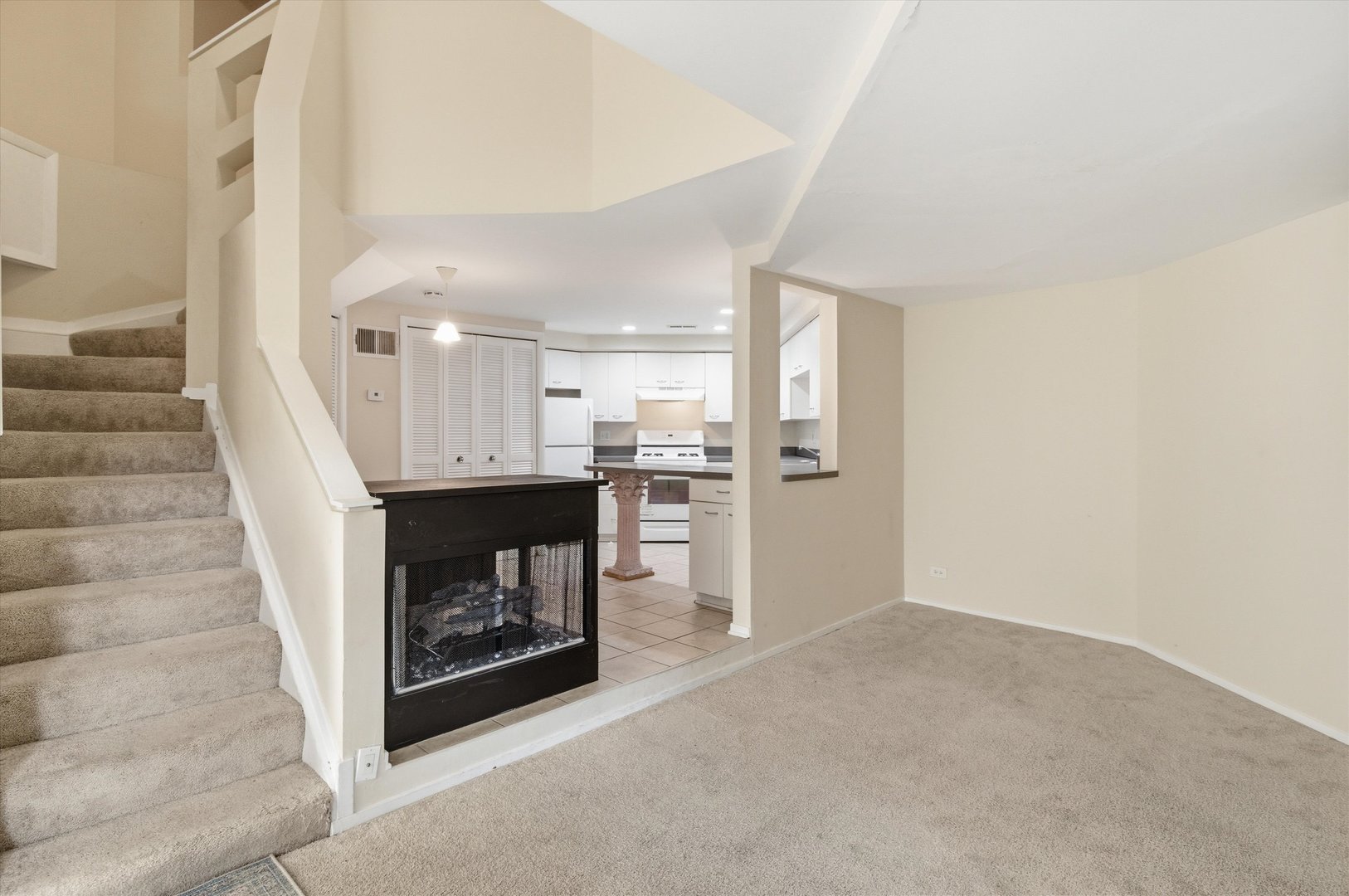 6337 Roosevelt Road, Unit 114 Berwyn, IL 60402 - Photo 3 of 33 a view of a hallway with wooden floors and a fireplace