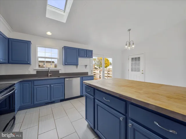 a kitchen with granite countertop a sink cabinets and window