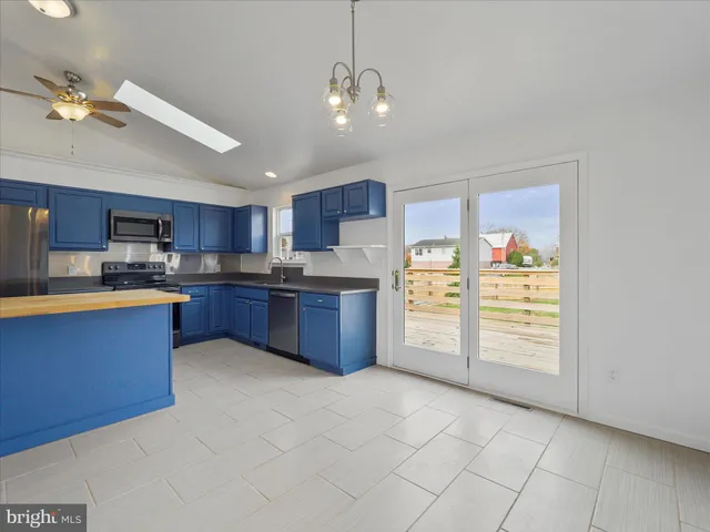 a kitchen with stainless steel appliances granite countertop a stove cabinets and entryway