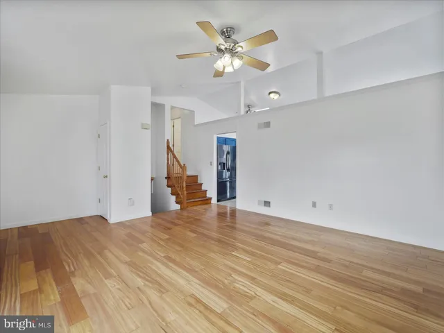 a view of an empty room with a ceiling fan