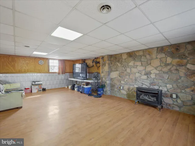 an empty room with furniture and a fireplace