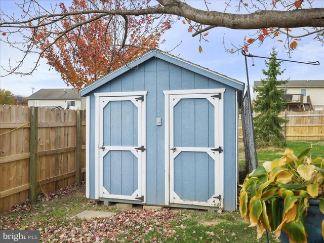 a view of a house with wooden fence