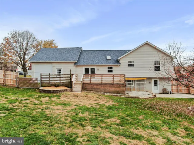 a front view of a house with a yard table and chairs