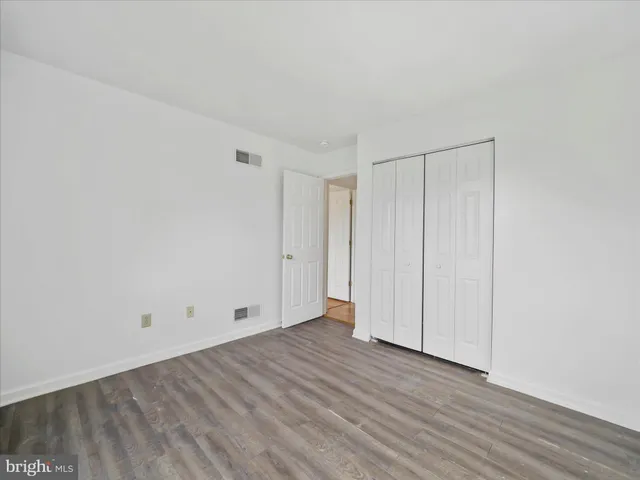 a view of room with wooden floor