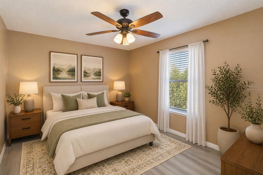 2327 Andrews Valley Drive Kissimmee, FL 34758 - Photo 12 of 42 a bedroom with a bed and a potted plant