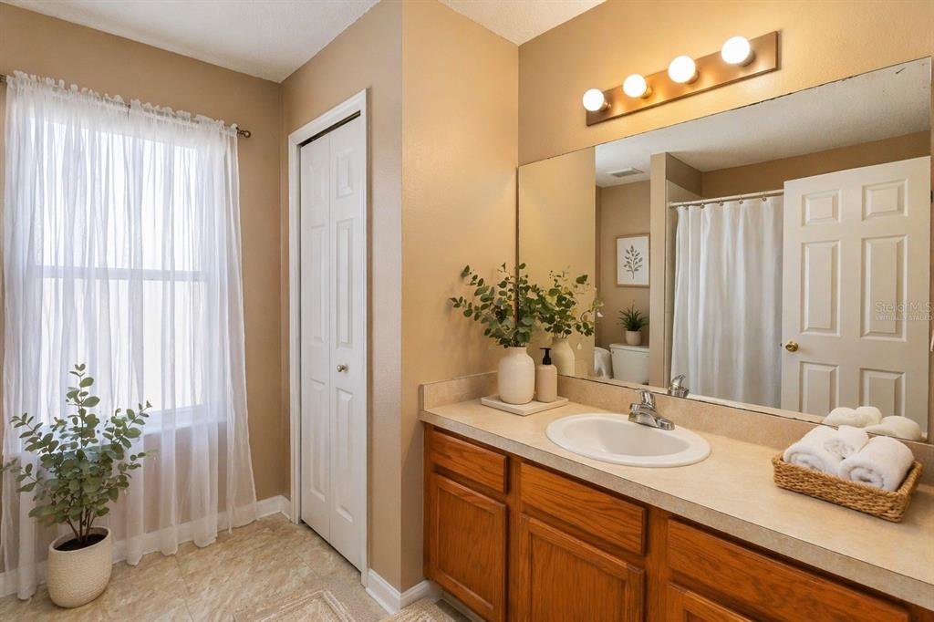 2327 Andrews Valley Drive Kissimmee, FL 34758 - Photo 15 of 42 a bathroom with a sink and a mirror