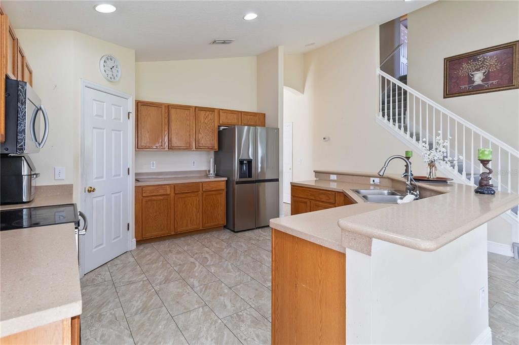 2327 Andrews Valley Drive Kissimmee, FL 34758 - Photo 21 of 42 a kitchen with stainless steel appliances a sink and a refrigerator