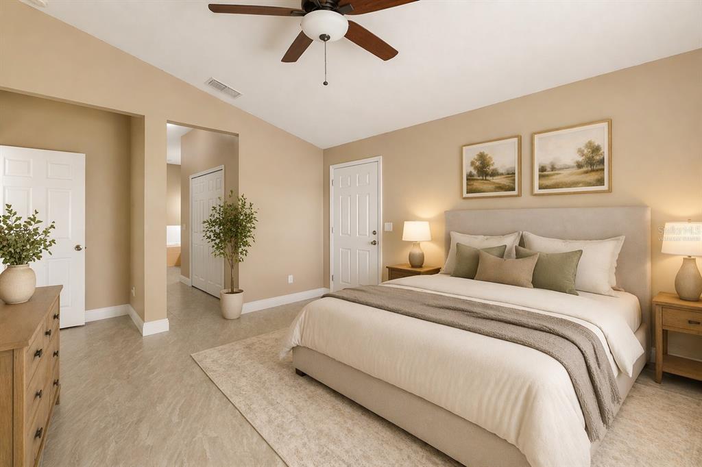 2327 Andrews Valley Drive Kissimmee, FL 34758 - Photo 6 of 42 a spacious bedroom with a large bed and potted plant