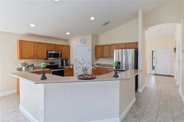 a kitchen with stainless steel appliances a sink and a refrigerator