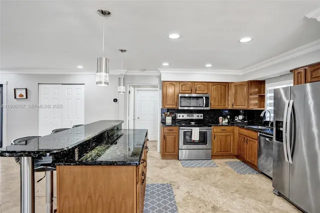 a kitchen with stainless steel appliances granite countertop a stove and a refrigerator