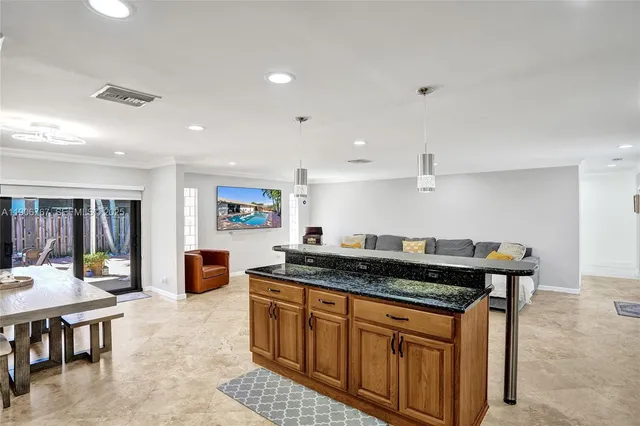 a kitchen with stainless steel appliances granite countertop a stove a sink and a refrigerator