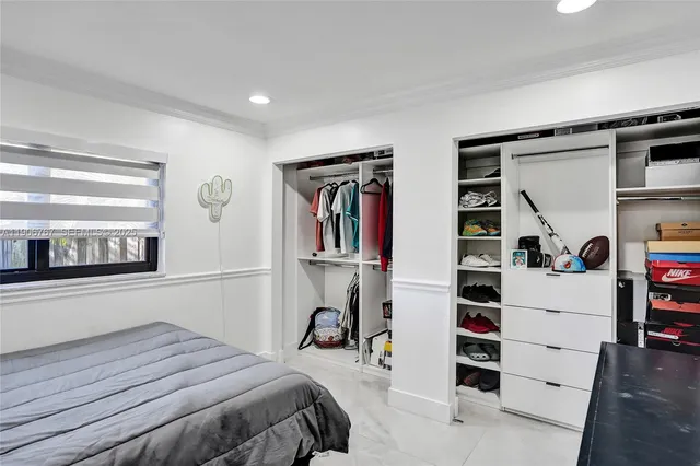 a bedroom with a bed and a cabinets