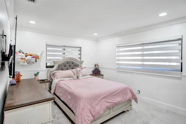 a bedroom with a bed and a dresser with the shoe rack