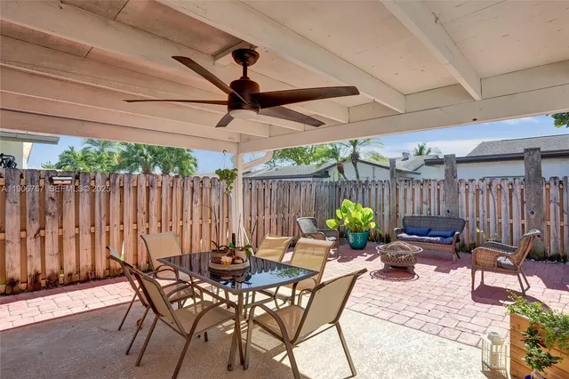 a view of a backyard with furniture and outdoor seating